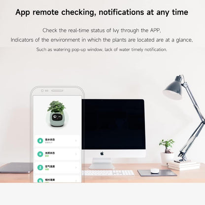 Smart plant monitor app displayed on a smartphone with a computer and desk setup.