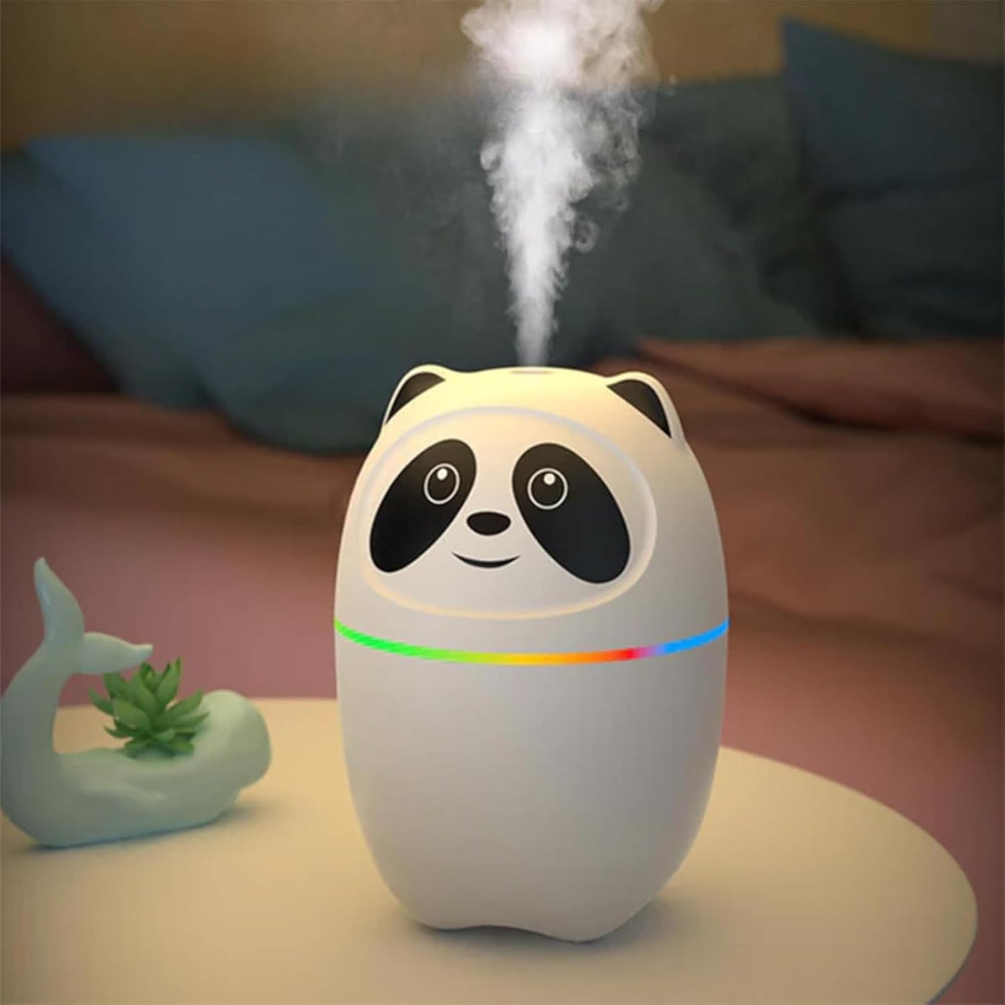 Panda-shaped humidifier emitting mist on a table with a blurred background