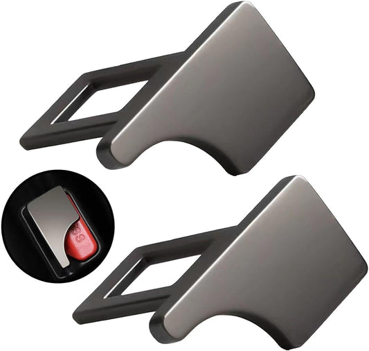 Two metallic car seat belt buckles on a white background