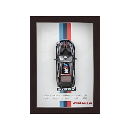 Model car in a black frame with branding on a white background