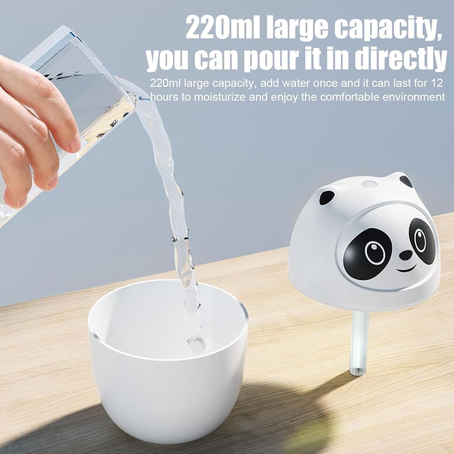 Panda-shaped humidifier with water being poured into it on a wooden surface.