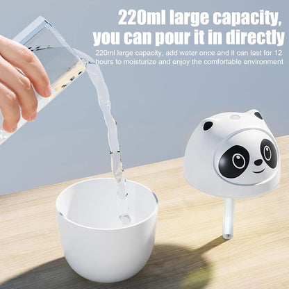 Panda-shaped humidifier with water being poured into it on a wooden surface.