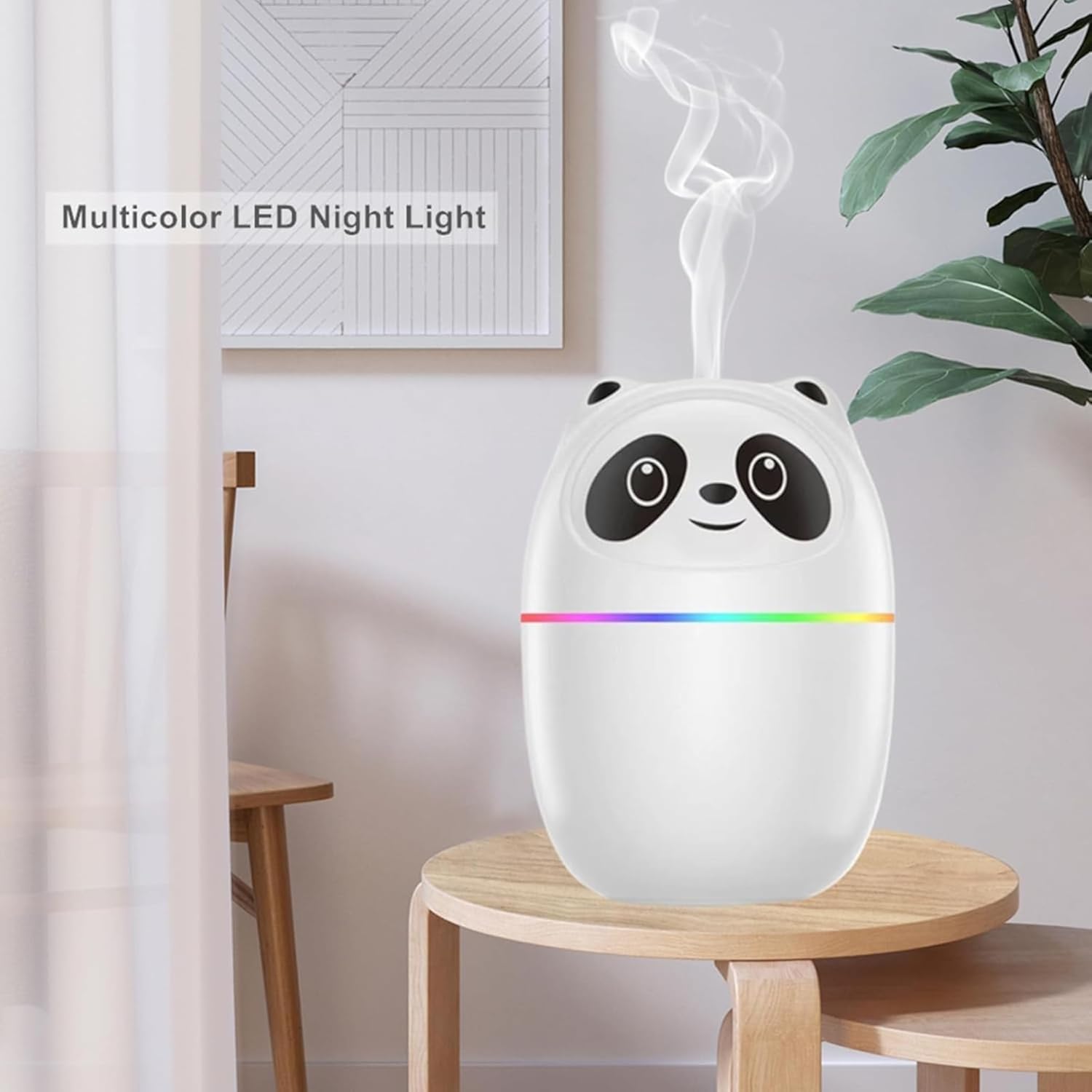 Multicolor LED night light shaped like a panda on a wooden stool with a plant and framed picture in the background.